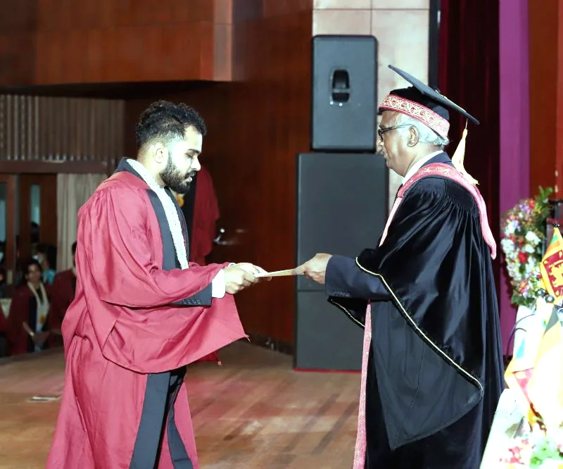 Jay in graduation robes receiving the MBA from the University of Moratuwa on stage