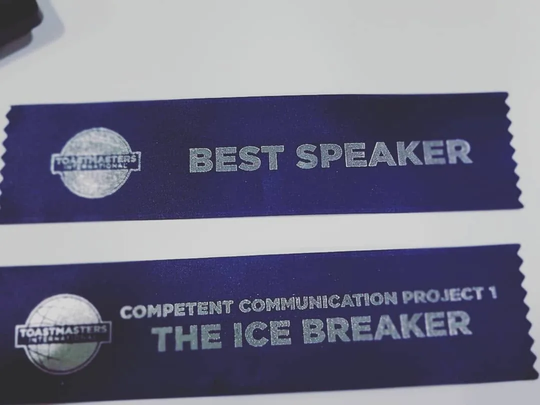 Two Toastmasters ribbons: Best Speaker, and Competent Communication Project 1, The Ice Breaker